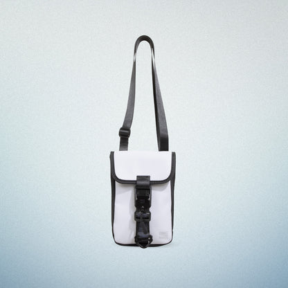 Front view of a white WAVEIT eco-friendly crossbody bag with black accents and a buckle closure, displayed on a light blue gradient background.