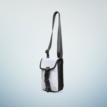 Side view of WAVEIT white eco-friendly crossbody bag with adjustable strap and buckle closure.