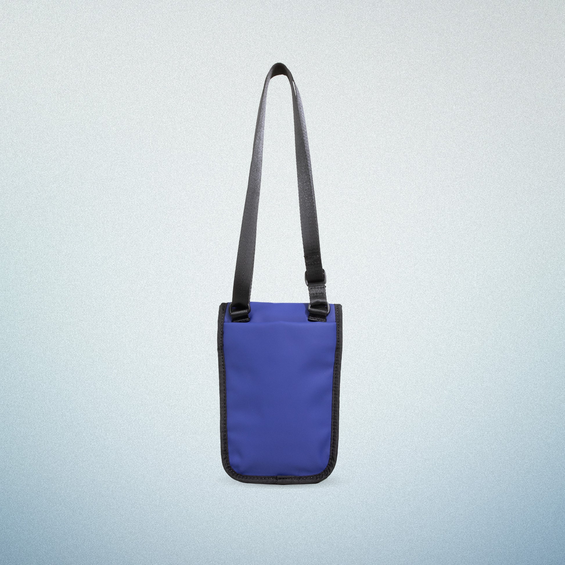 Back view of WAVEIT blue eco-friendly crossbody bag with adjustable strap, showcasing a minimalist and sustainable design.