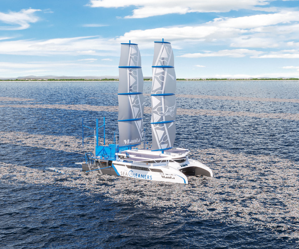 A modern sailboat from the Manta Project designed for ocean cleanup, sailing on open water under a clear sky